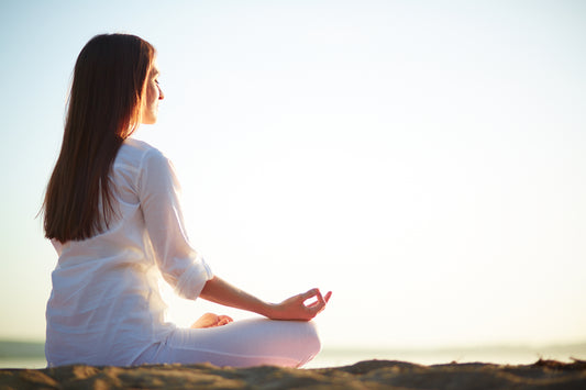 Woman sitting with palms turned up meditating